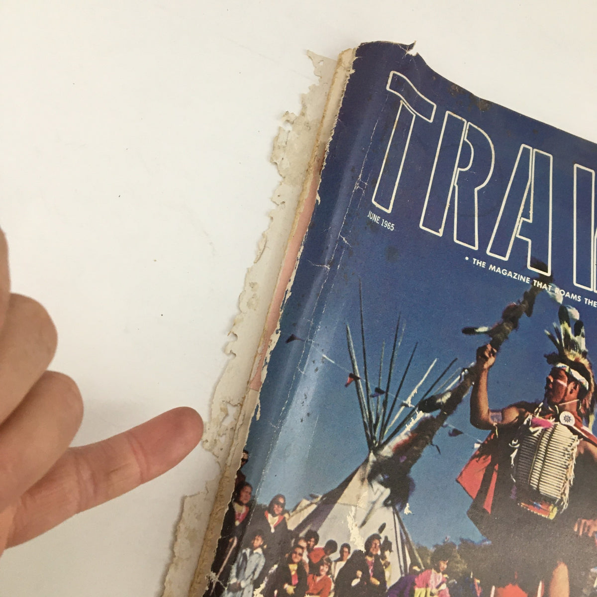 Side view of the Travel Magazine June 1965 showing wear and tear typical for vintage issues, highlighting its historical significance.