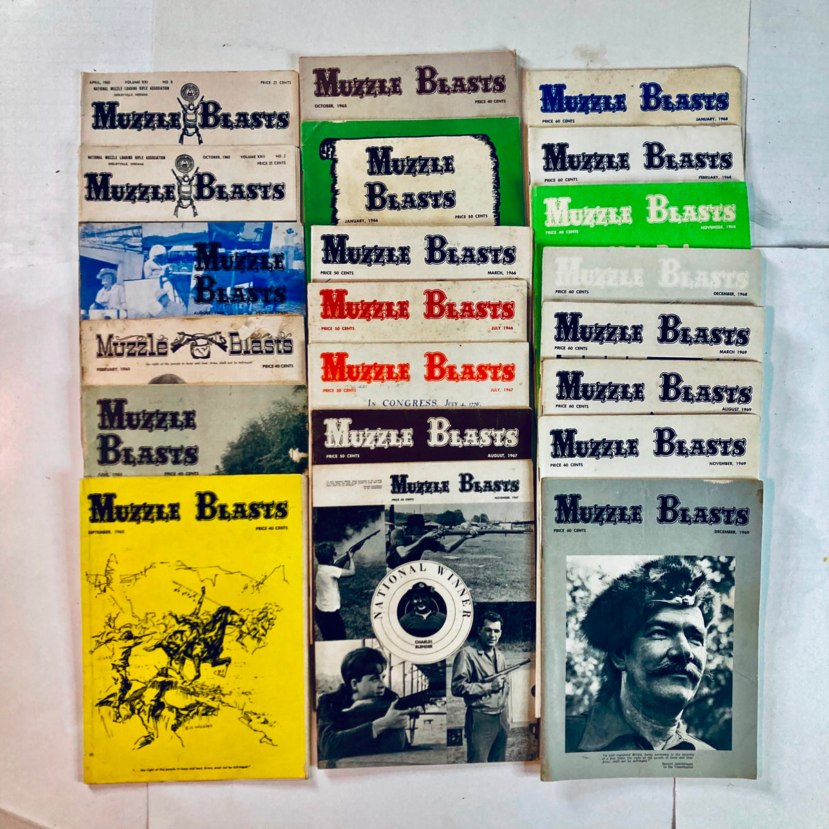 Collection of 21 Muzzle Blasts magazines from the 1960s showcasing various issues, featuring diverse covers and highlighting traditional craftsmanship and living history.
