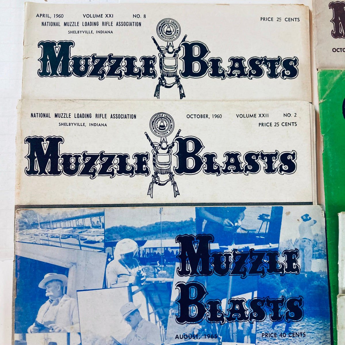 Top view of three Muzzle Blasts magazines dated April 1960, October 1960, and August 1965, emphasizing their vintage appeal and connection to muzzle-loading heritage.