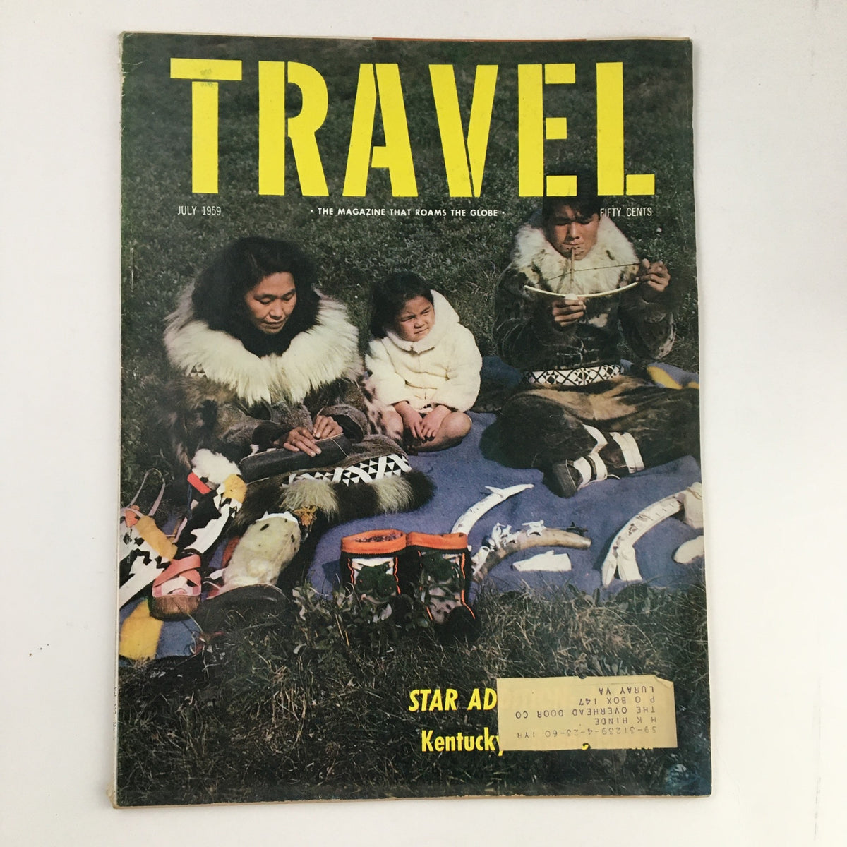 Cover of VTG Travel Magazine from July 1959 featuring the title 'TRAVEL', showcasing individuals in traditional attire engaged in craftwork, highlighting the allure of the article 'Star Addition: Alaska'.
