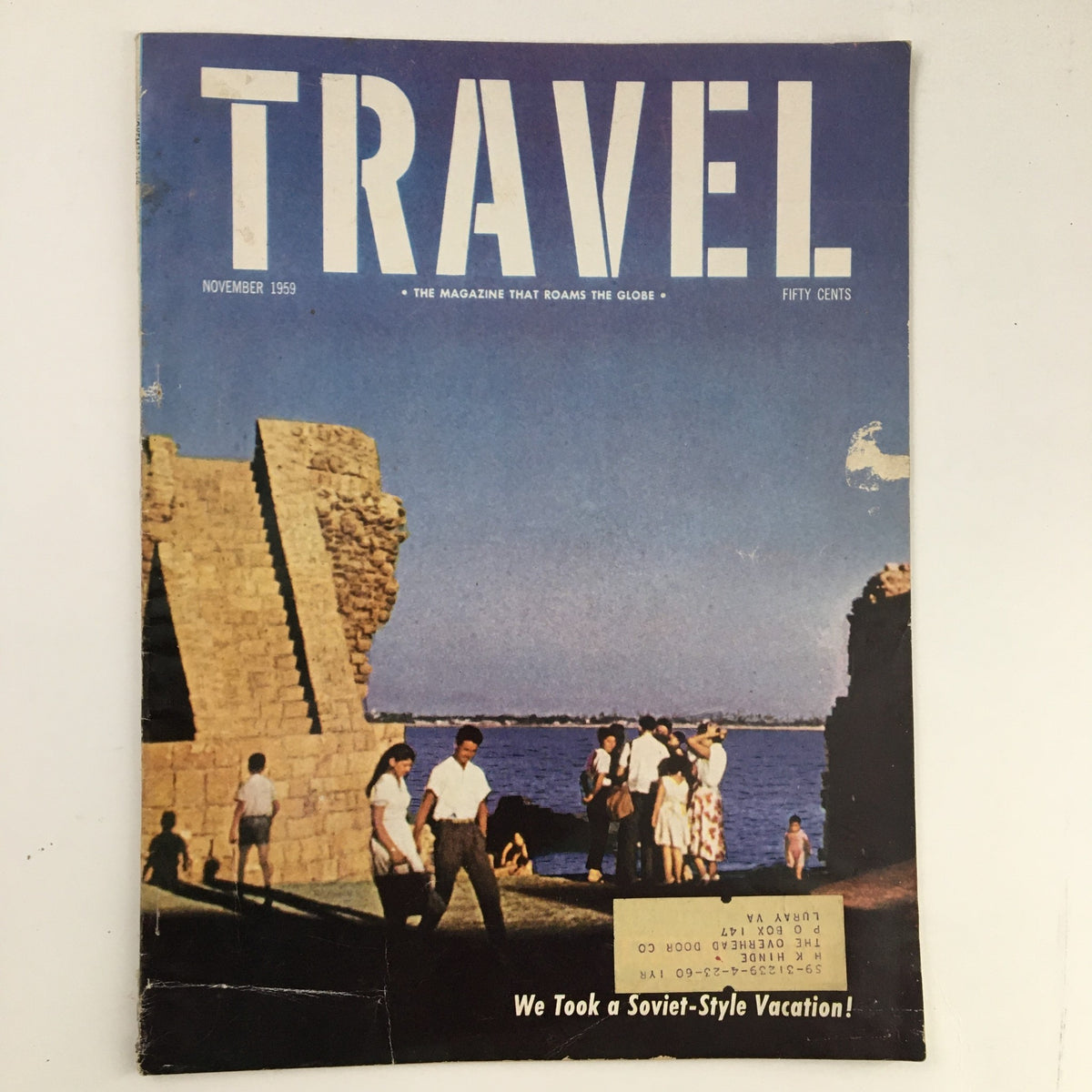 Cover of VTG Travel Magazine November 1959 featuring weathered stones at Acre, Israel and visitors exploring the scenic coastal view.