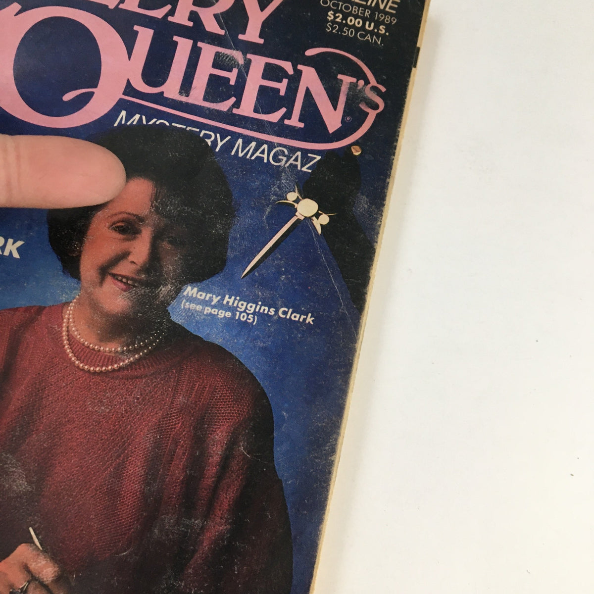 Close-up view of the cover of Ellery Queen's Mystery Magazine October 1989 highlighting Mary Higgins Clark. The design features the title prominently with a detailed article listing.