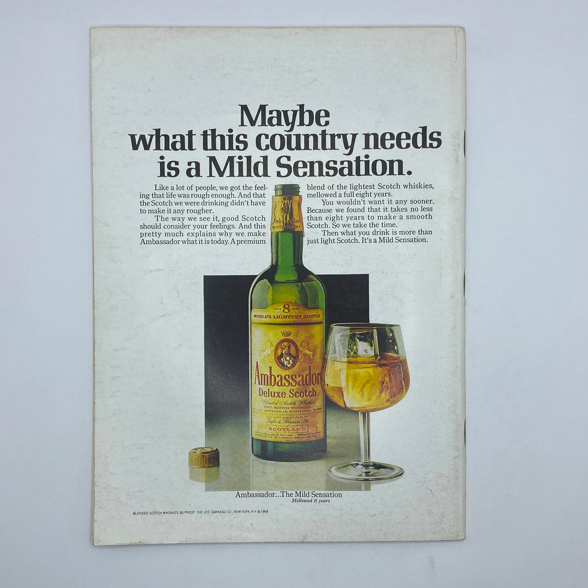 Advertisement from the back cover of The New Yorker Complete Magazine August 16, 1969 promoting Ambassador Deluxe Scotch with a bottle and glass.