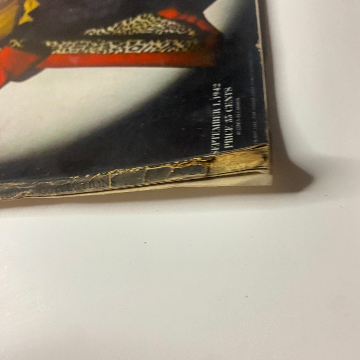 Side view of Vogue Magazine September 1, 1942 showing the cover with Meg Mundy. Visible creases and edge wear are present.