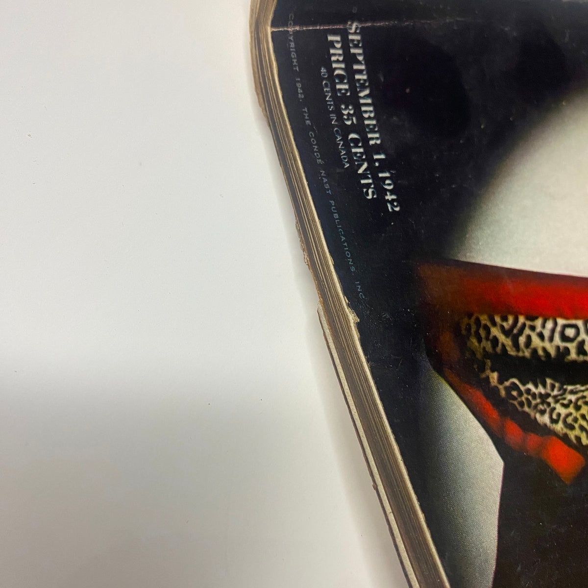 Detailed view of the corner of Vogue Magazine September 1, 1942 featuring Meg Mundy, highlighting the worn edge of the cover.