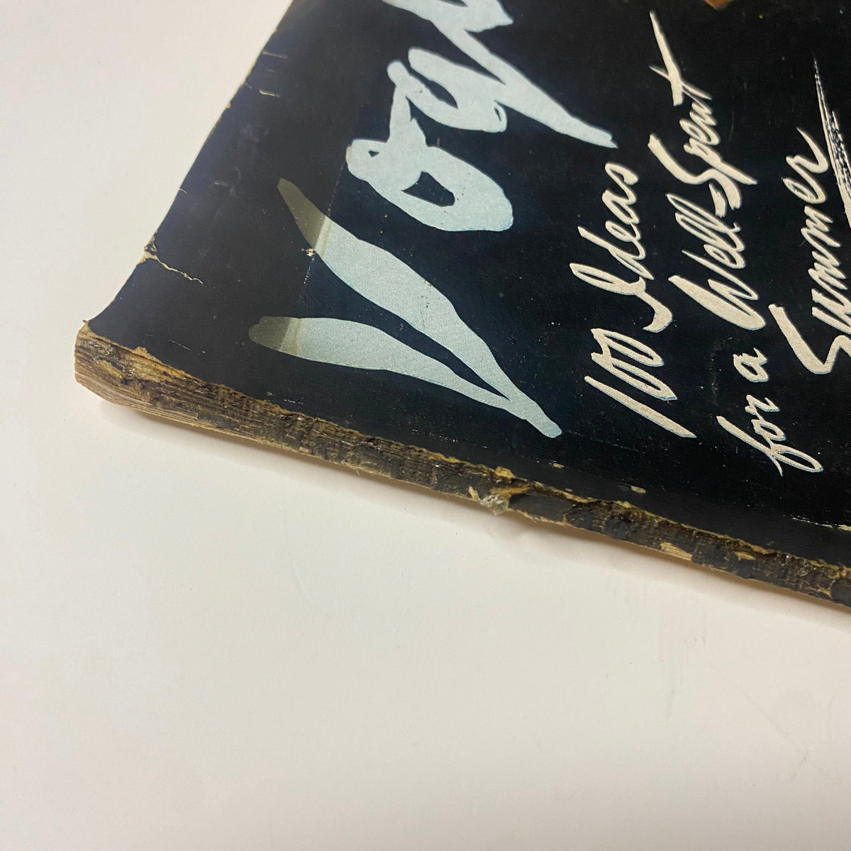Detail of Vogue Magazine June 1, 1942 showing wear on the spine of the cover, reflecting its vintage condition. Features Betty McLauchlen and summer fashion ideas.