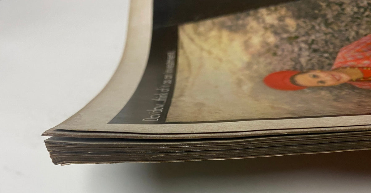 Close-up of the worn spine of Vogue Magazine August 1, 1968 Joanna Shimkus Cover by David Bailey, showcasing its vintage condition.