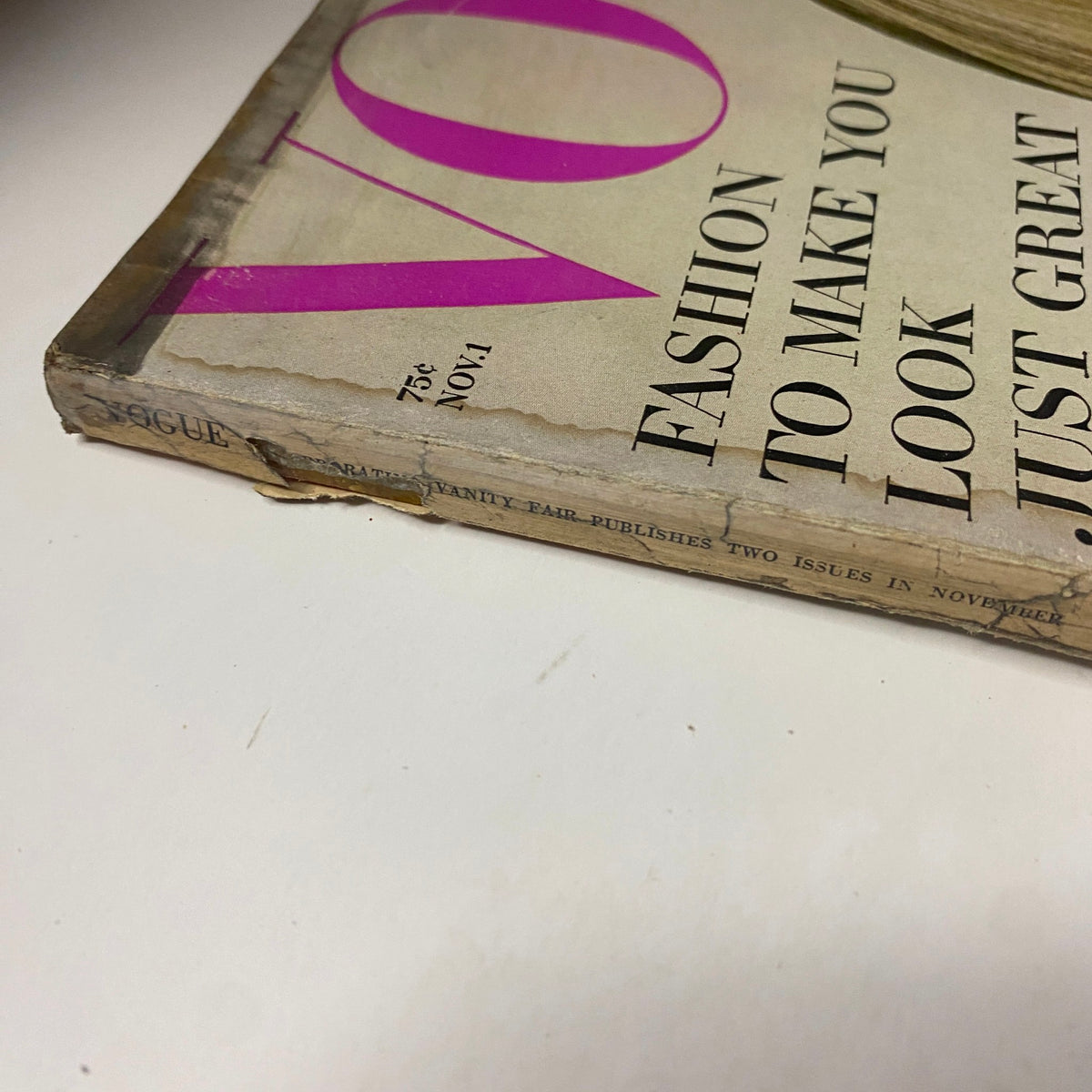Spine of Vogue Magazine November 1, 1966, showing signs of vintage wear with a visible tear, emphasizing the magazine's historical significance.