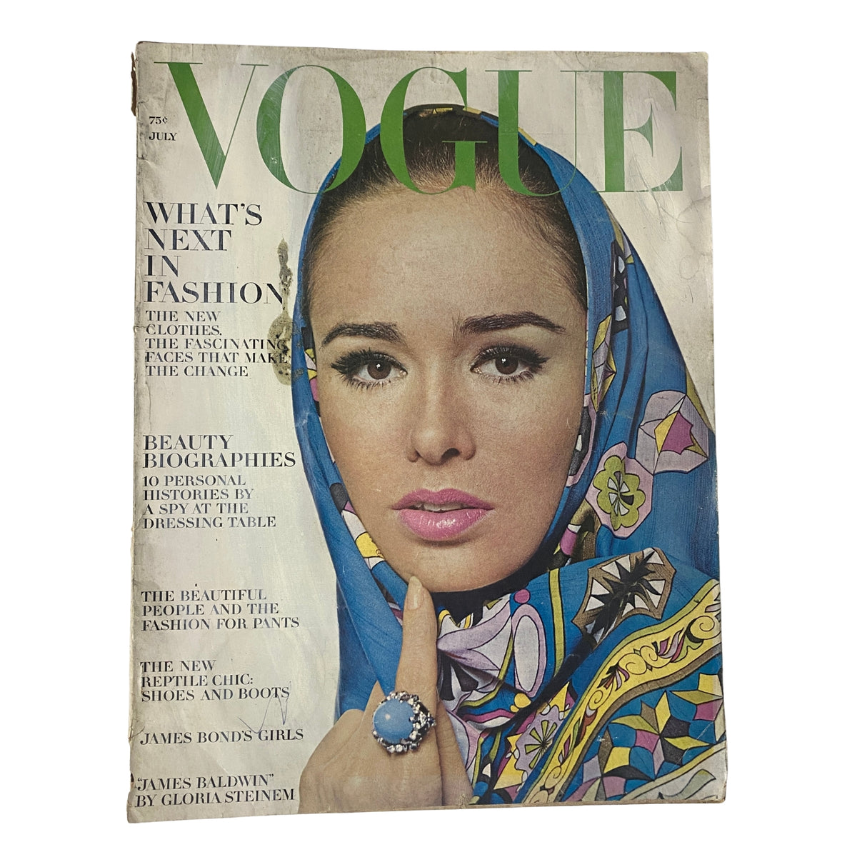 Vogue Magazine July 1964, featuring a cover photo of Sondra Peterson by Irving Penn, showcasing a vibrant headscarf and bold makeup. The classic magazine embodies mid-1960s fashion and elegance.