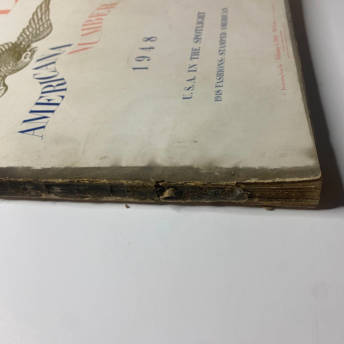 Close-up of the damaged edge of Vogue Magazine February 1, 1948 Americana Number, illustrating its vintage condition and authenticity.