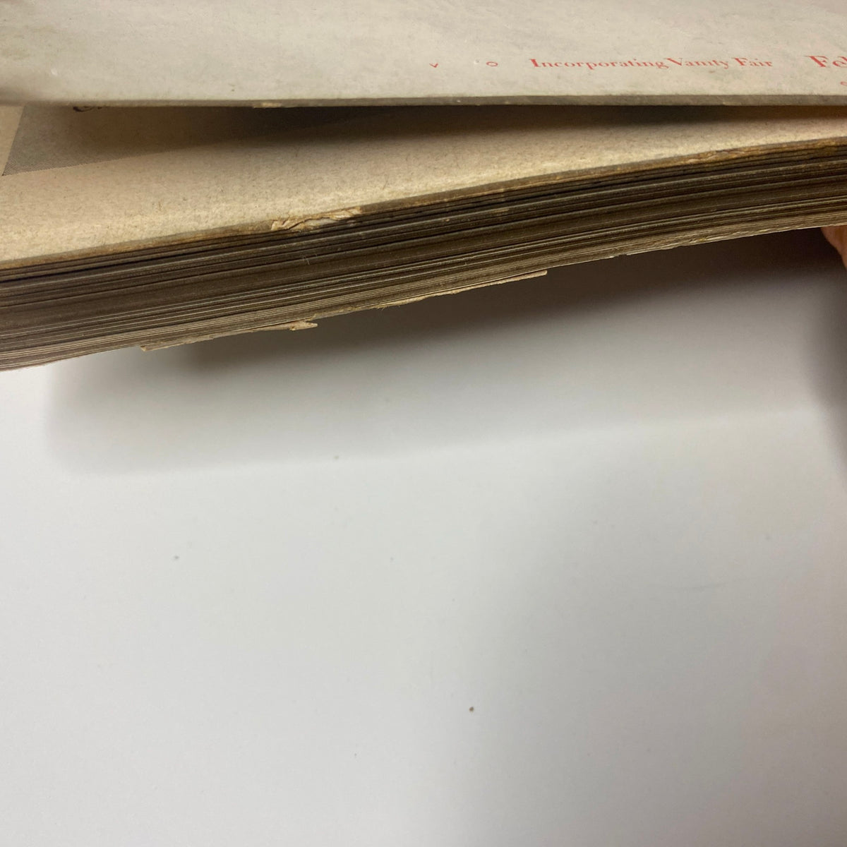Close-up view of the spine and edges of Vogue Magazine February 1, 1948 Americana Number 1948, showcasing wear from vintage storage.