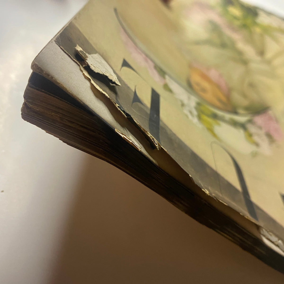 Detailed shot of the edge of Vogue Magazine April 15, 1948 revealing torn areas, indicative of its age and previous handling.