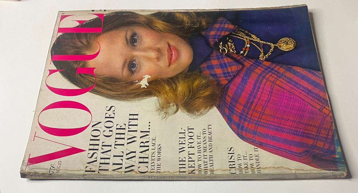 Close-up view of the vintage Vogue Magazine August 15, 1968 cover featuring Lauren Hutton by Gianni Penati, highlighting a glamorous model adorned with a statement necklace.
