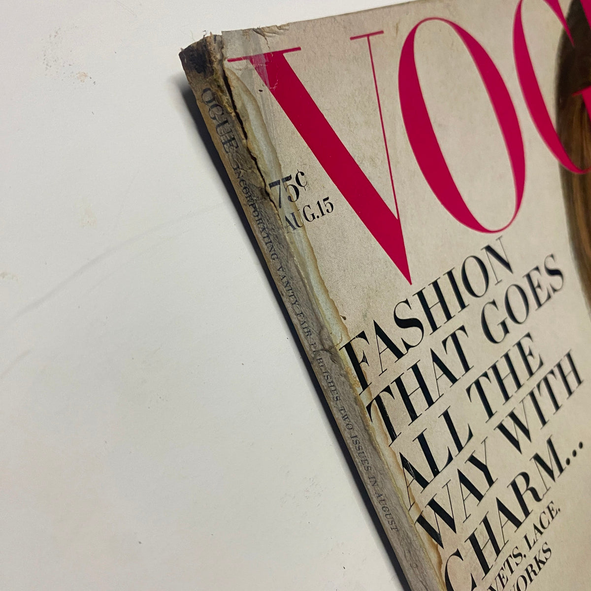 Side view of the vintage Vogue Magazine August 15, 1968 showing wear and age, with visible spine condition and cover art featuring Lauren Hutton by Gianni Penati.
