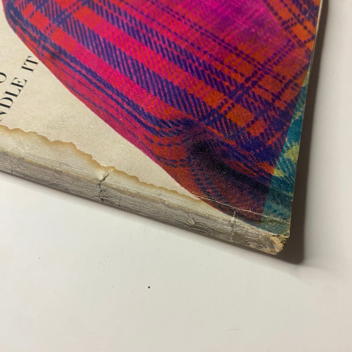 Detailed image of the edge of the vintage Vogue Magazine August 15, 1968, displaying wear and slight damage along the cover, featuring Lauren Hutton by Gianni Penati.