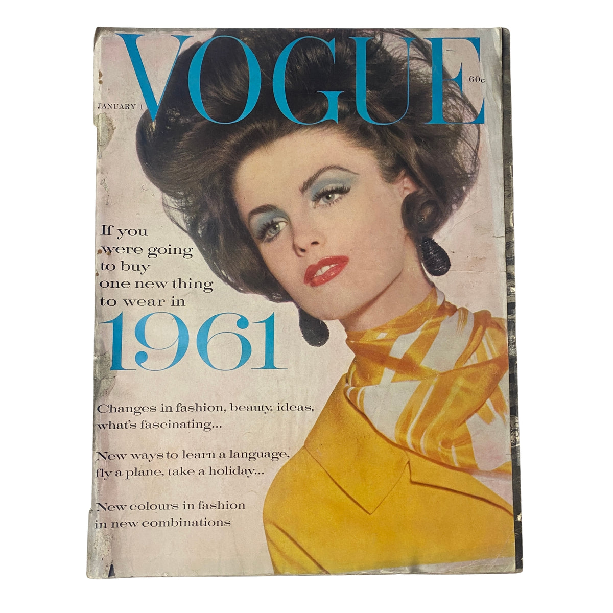 Cover of Vogue Magazine January 1, 1961 featuring model Dorothy McGowan, photographed by Irving Penn, showcasing bold fashion with vibrant colors and distinct 1960s style.
