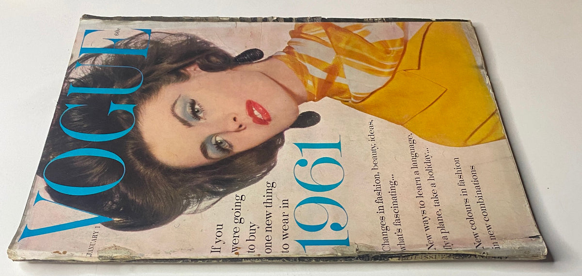 Cover image of Vogue Magazine January 1, 1961 displaying Dorothy McGowan with striking makeup and vintage fashion, emphasizing the elegance of early 1960s styles.