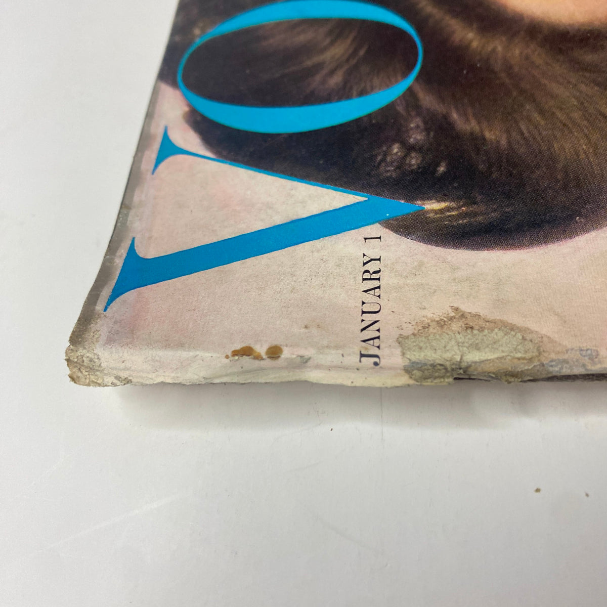 Close-up of the outer spine of Vogue Magazine January 1, 1961, illustrating light wear and age, characteristic of vintage magazines, capturing the essence of its historical significance.