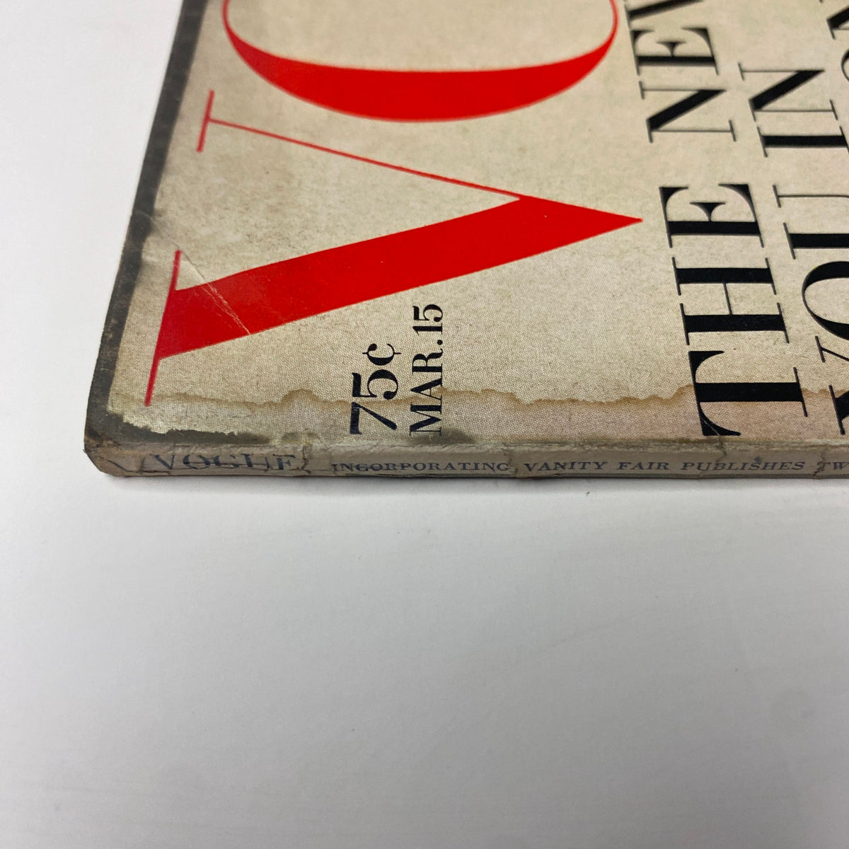 Close-up view of the spine of Vogue Magazine March 15, 1969, showing details including the date and price of 75 cents. The wear indicates its vintage condition and authenticity.