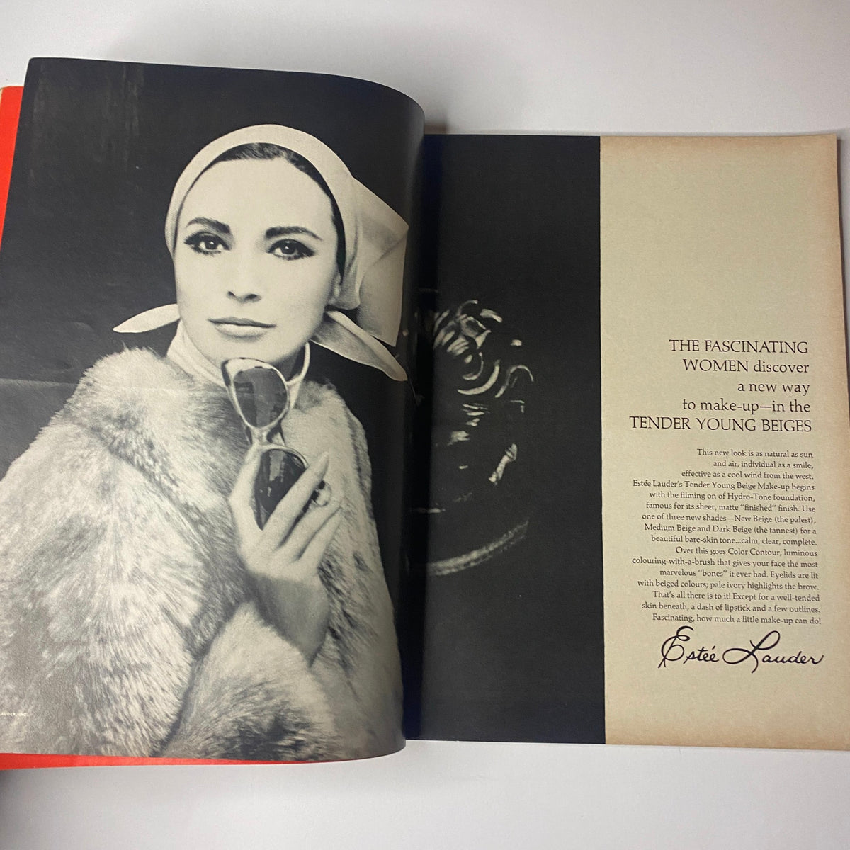 High-fashion advertisement from Vogue Magazine, October 1, 1964, showcasing Estée Lauder's product with a model exuding glamour and style characteristic of the 1960s.