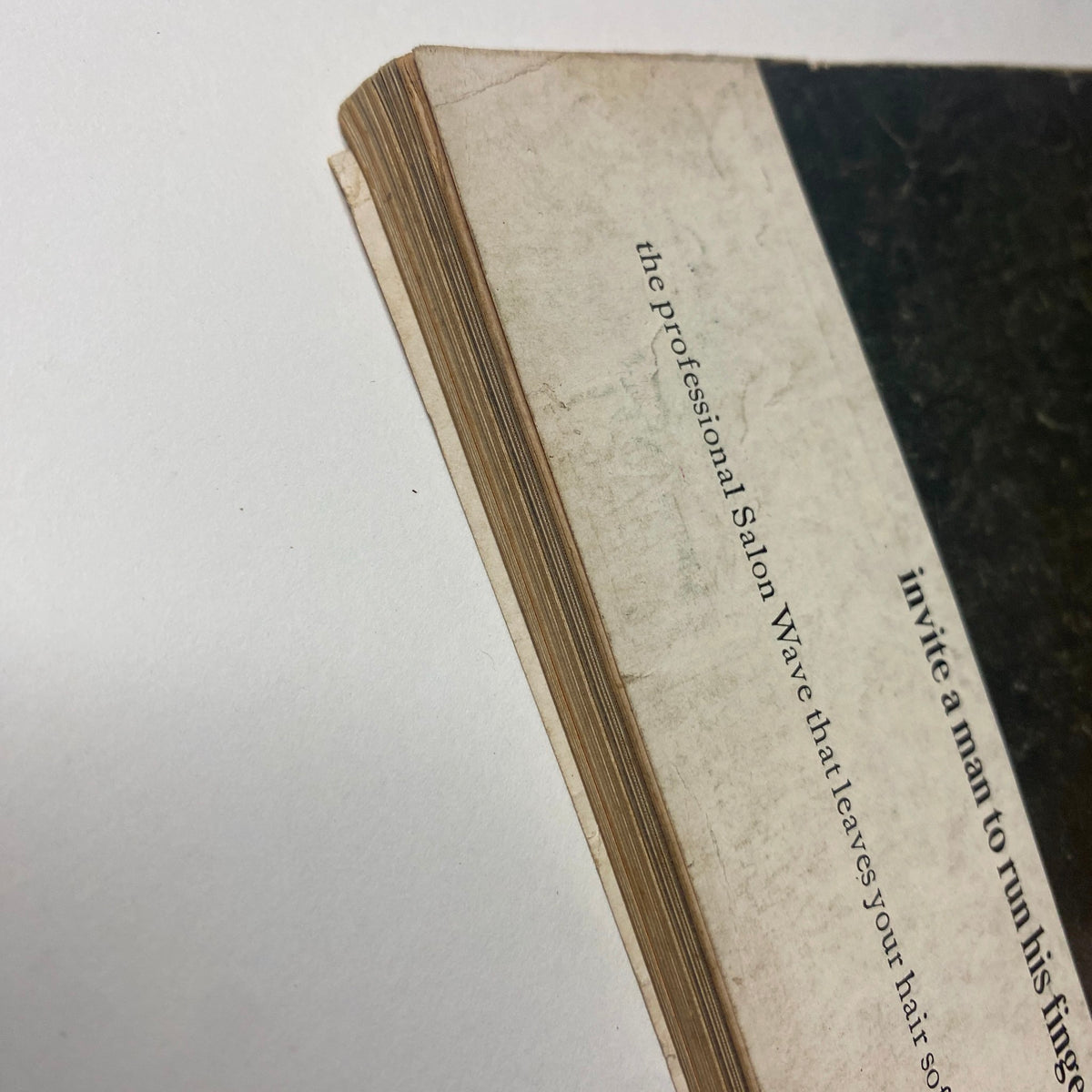 Close-up of the spine of the October 1, 1964 issue of Vogue Magazine, highlighting the aged condition and texture of the pages, indicative of its vintage authenticity.