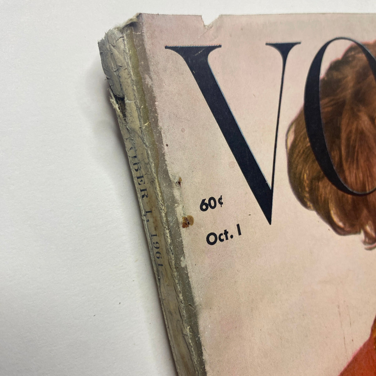 Close-up view of the spine of Vogue Magazine October 1, 1961, showing slight wear and vintage characteristics, typical of its age. The cover features Dorothy McGowan, photographed by Irving Penn.