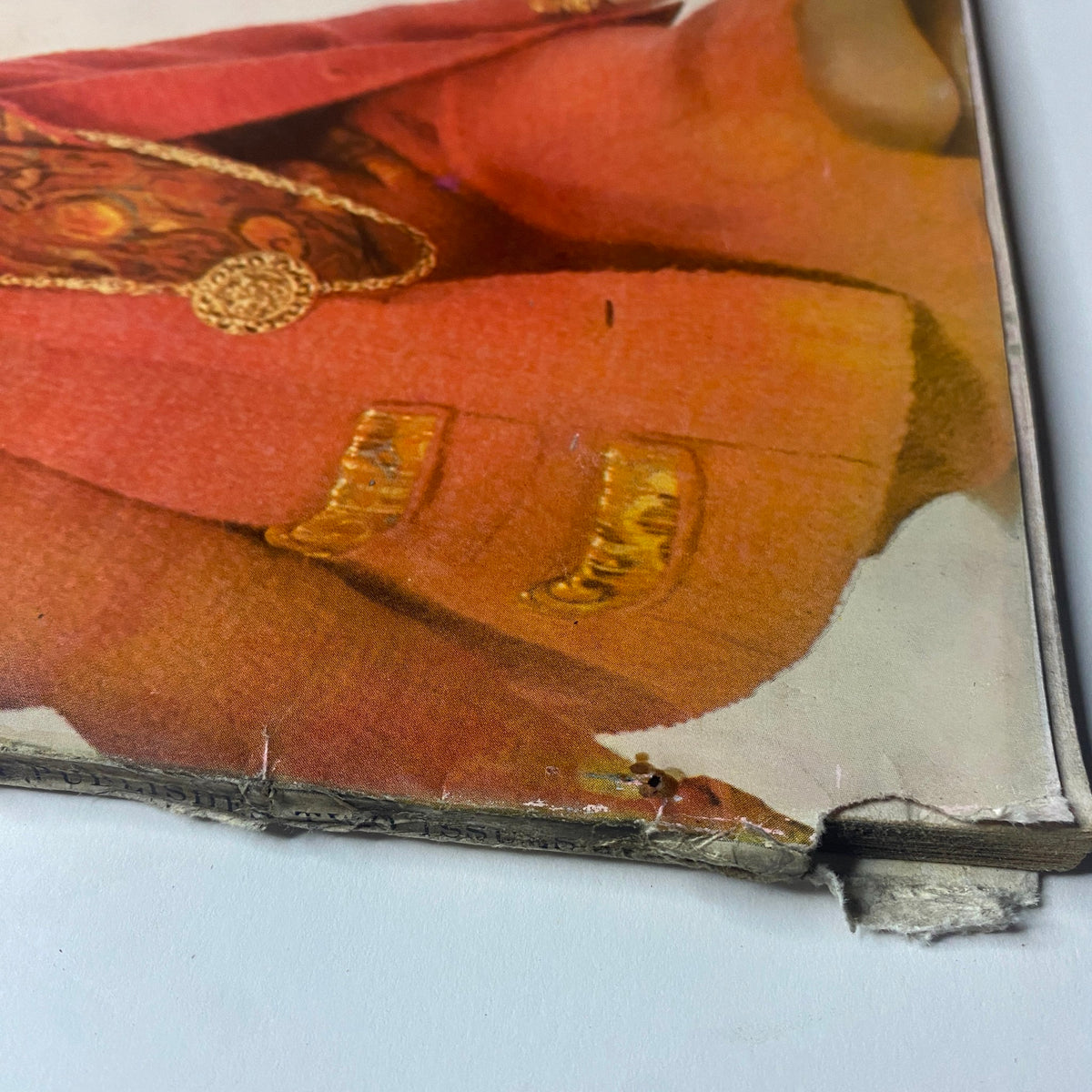 Close-up view of the edge of Vogue Magazine October 1, 1961 Dorothy McGowan Cover by Irving Penn, showing wear and tear on the spine.