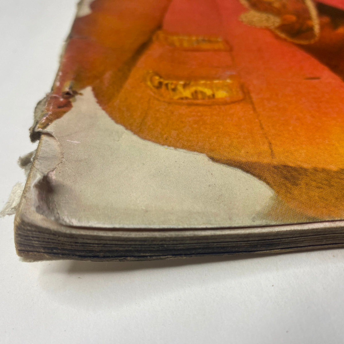 Close-up view of the spine of Vogue Magazine October 1, 1961 Dorothy McGowan Cover by Irving Penn, showing wear and age with frayed edges.