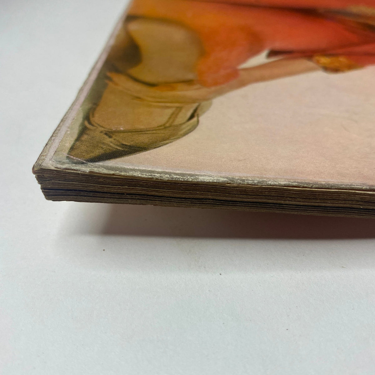 Detailed image of the side of Vogue Magazine October 1, 1961 Dorothy McGowan Cover by Irving Penn, highlighting the vintage characteristics and slight discoloration.