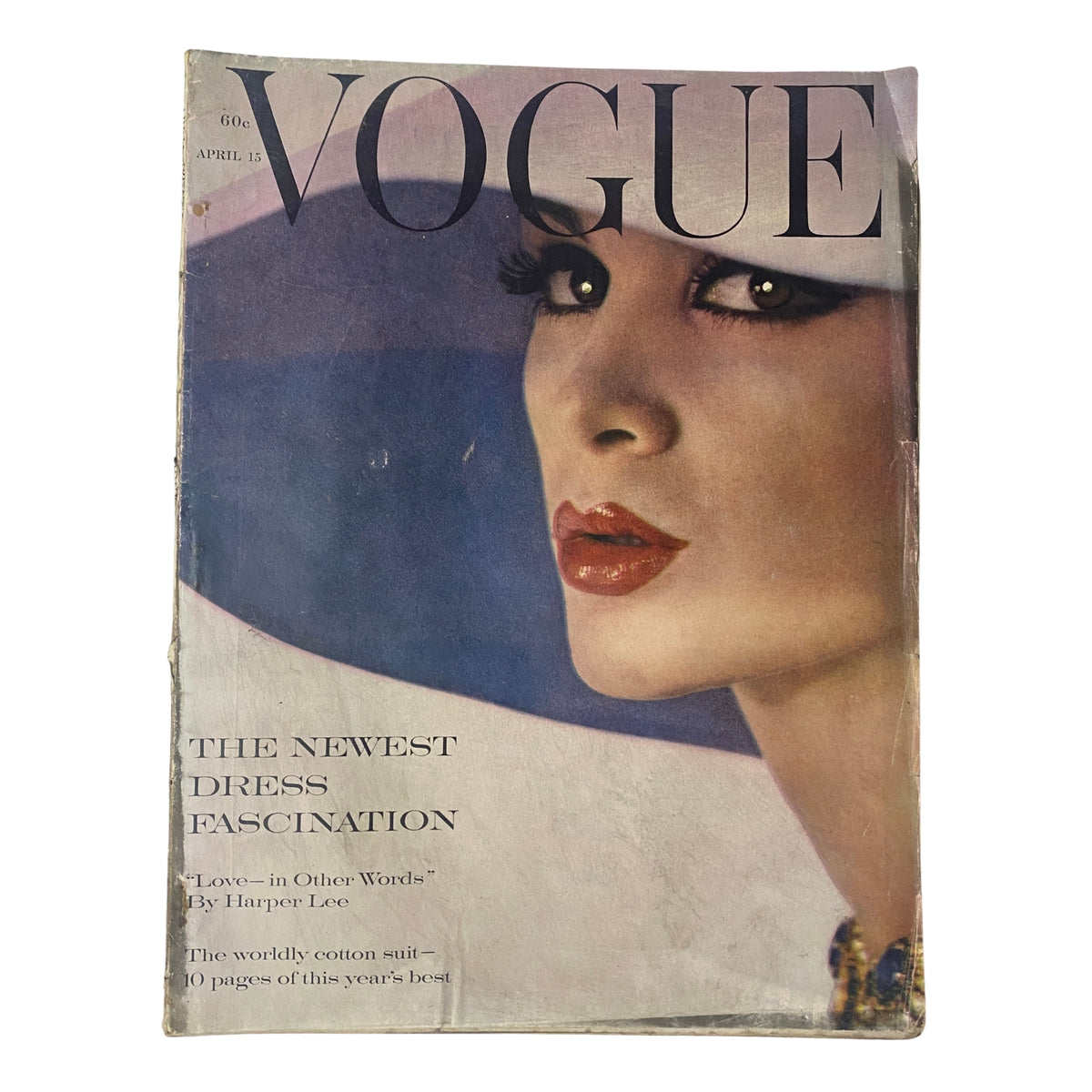 Vogue Magazine April 15, 1961 featuring Isabella Albonico on the cover, photographed by William Klein, showcasing bold makeup and fashion details.