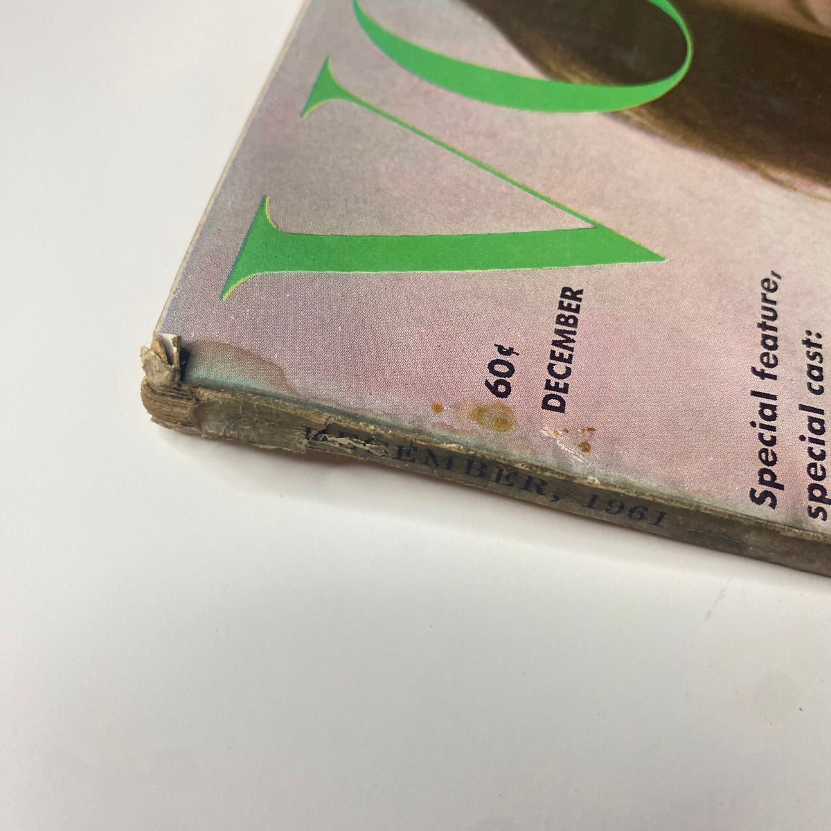 Detailed view of the spine of Vogue Magazine December 1961 Antonia Boekestyn Cover by Horst P. Horst, highlighting light wear and vintage characteristics.
