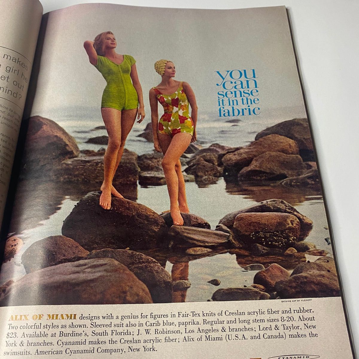 Alix of Miami swimsuit advertisement with two models showcasing vibrant swimwear on rocks, illustrating the fashion trends of the early 1960s. Original Vogue Magazine December 1961 Antonia Boekestyn Cover by Horst P. Horst.
