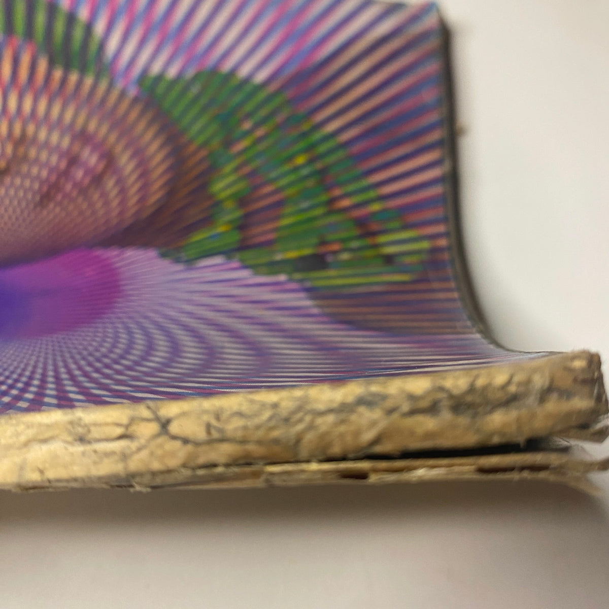 Detailed image showing the spine of Vogue Magazine June 1965, capturing the vintage essence and notable optical illusion graphics on the cover.