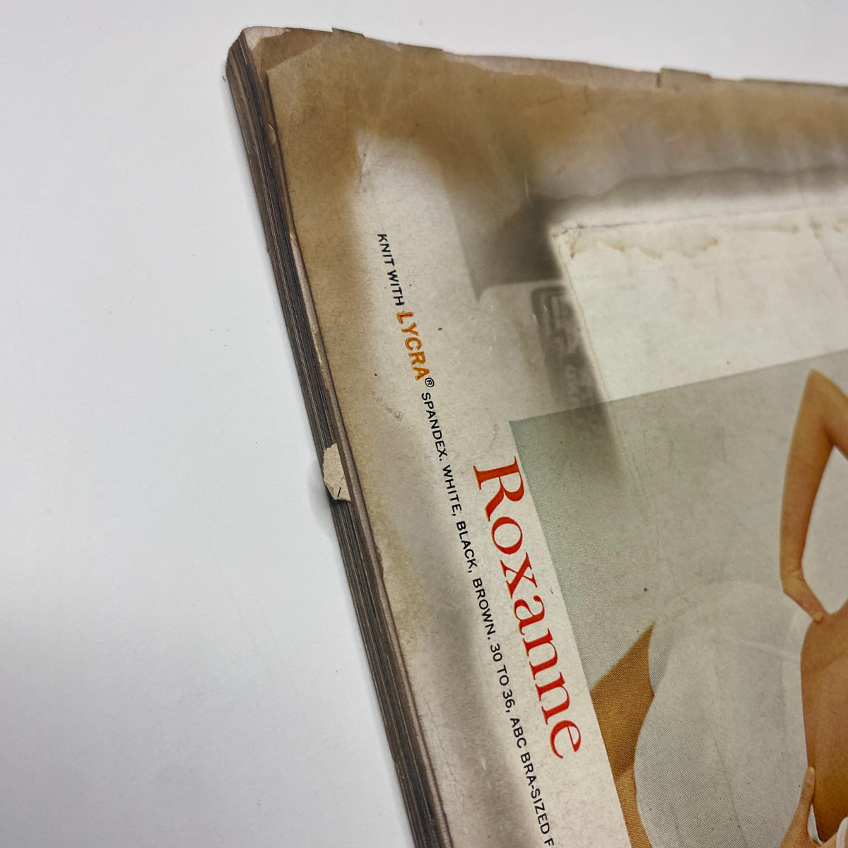 Vogue Magazine June 1965 – Brigitte Bauer Cover by Irving Penn. A close-up shot of the vintage magazine's outer spine displaying wear and age, revealing its history and authenticity as a collectible magazine.