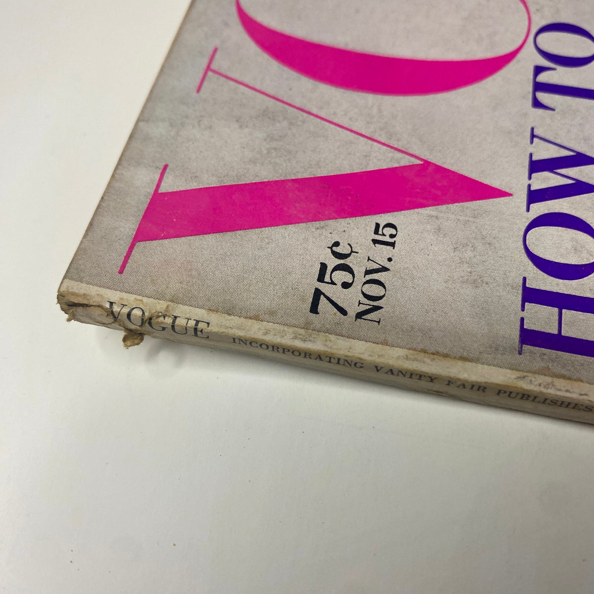 Close-up view of the spine of Vogue Magazine from November 15, 1969, showing minor wear, preserving historical context and vintage details.