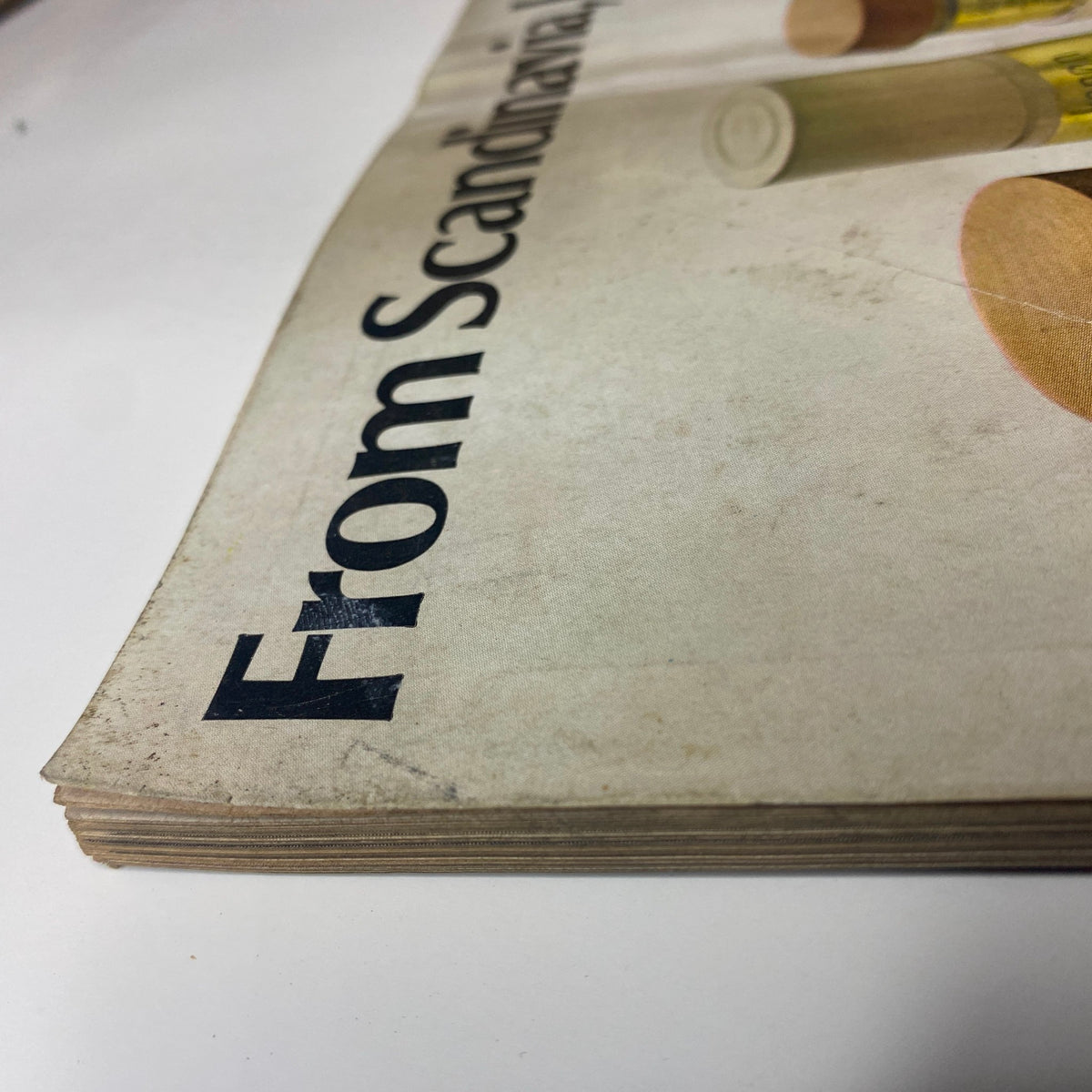 Close-up view of the edge of a vintage Vogue Magazine from November 15, 1969 featuring Françoise Rubartelli on the cover, highlighting wear and patina indicative of its age.