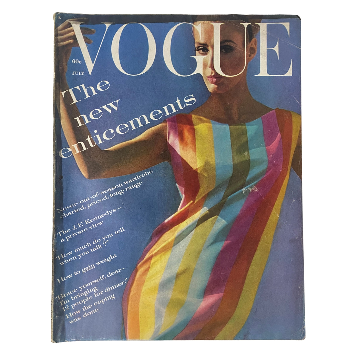 Vogue Magazine July 1961 featuring Deborah Dixon on the cover, showcasing a vibrant dress with colorful stripes. Iconic photography by Bert Stern highlights the essence of summer fashion.