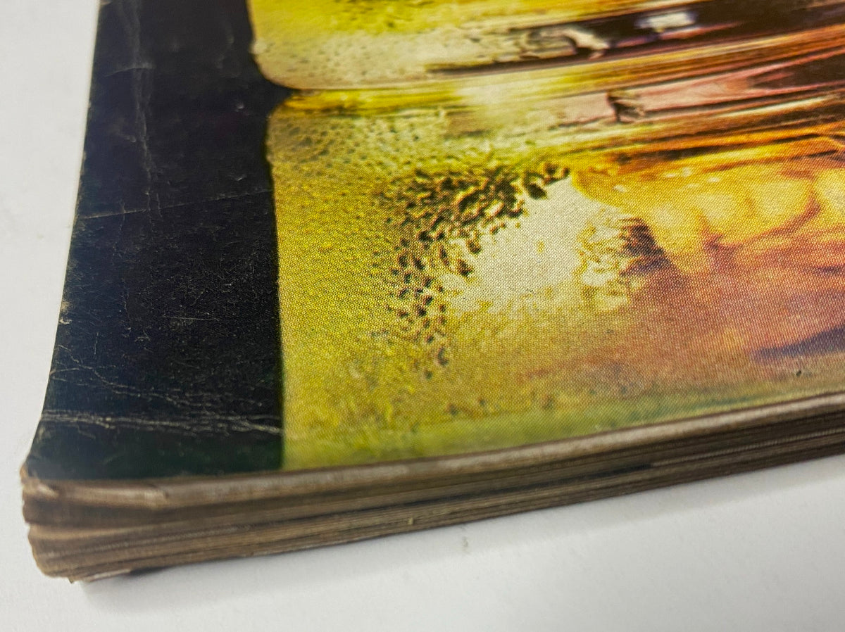 Close-up of the spine of Vogue Magazine July 1969, showing the worn cover and aged pages, emphasizing the vintage characteristics of the magazine.