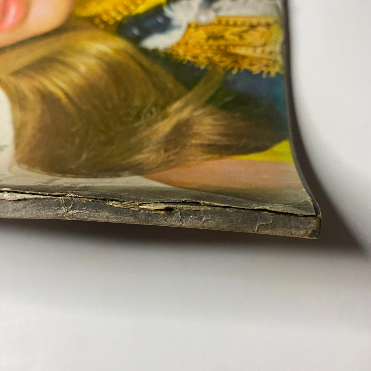 Detailed view of the edge of Vogue Magazine July 1968, revealing wear and characteristics of vintage magazines, featuring Lauren Hutton on the cover.
