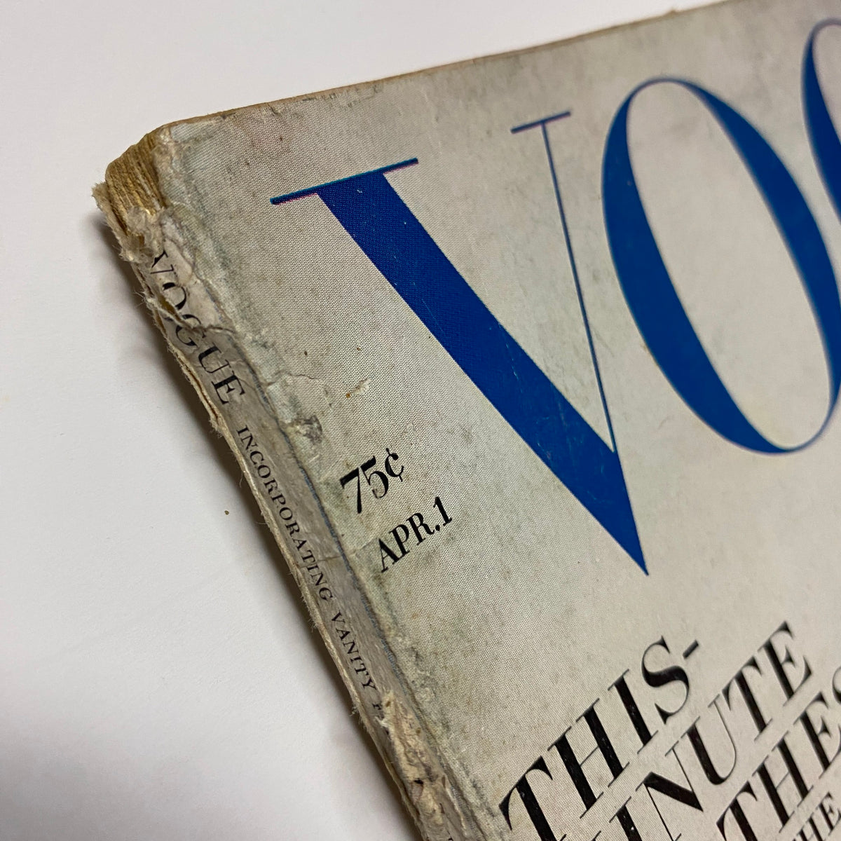 Side view of Vogue Magazine April 1, 1964, highlighting the iconic title and date while revealing the vintage condition of the magazine, featuring Brigitte Bauer on the cover.