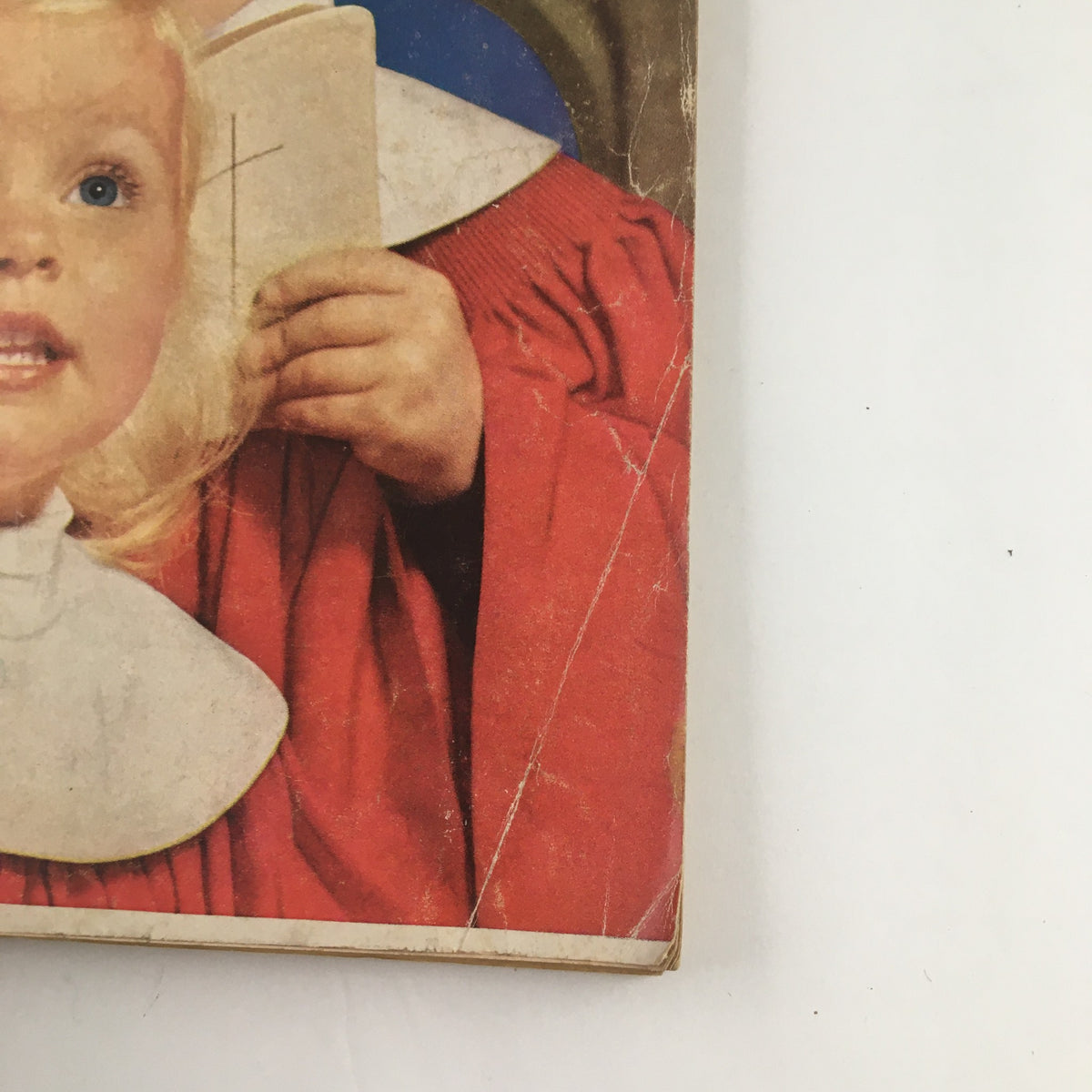 Close-up of the cover of Good Housekeeping Magazine December 1958 showing a child holding a book, part of the Christmas issue's nostalgic charm.