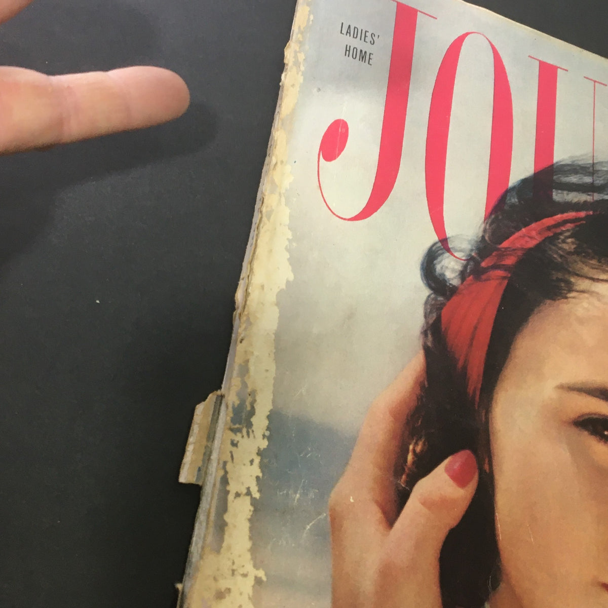 Close-up of the VTG Journal Magazine September 1955 cover, showcasing minor wear and a hand gently touching the magazine's edge.