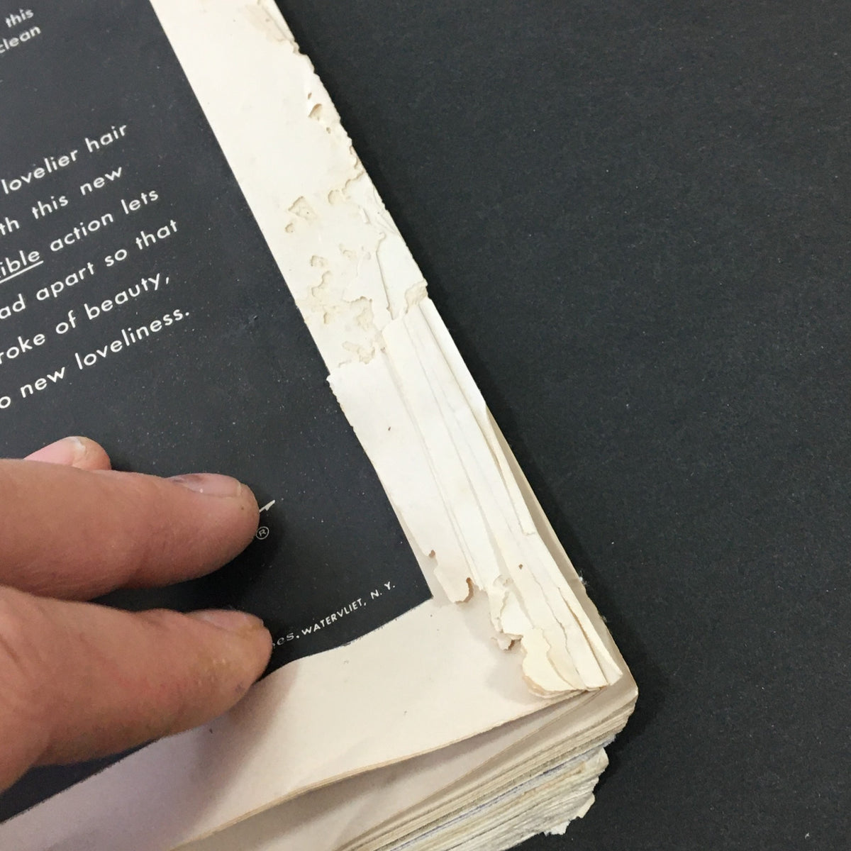 Detailed view of the vintage December 1954 VTG Journal Magazine spine, showing wear and tear.
