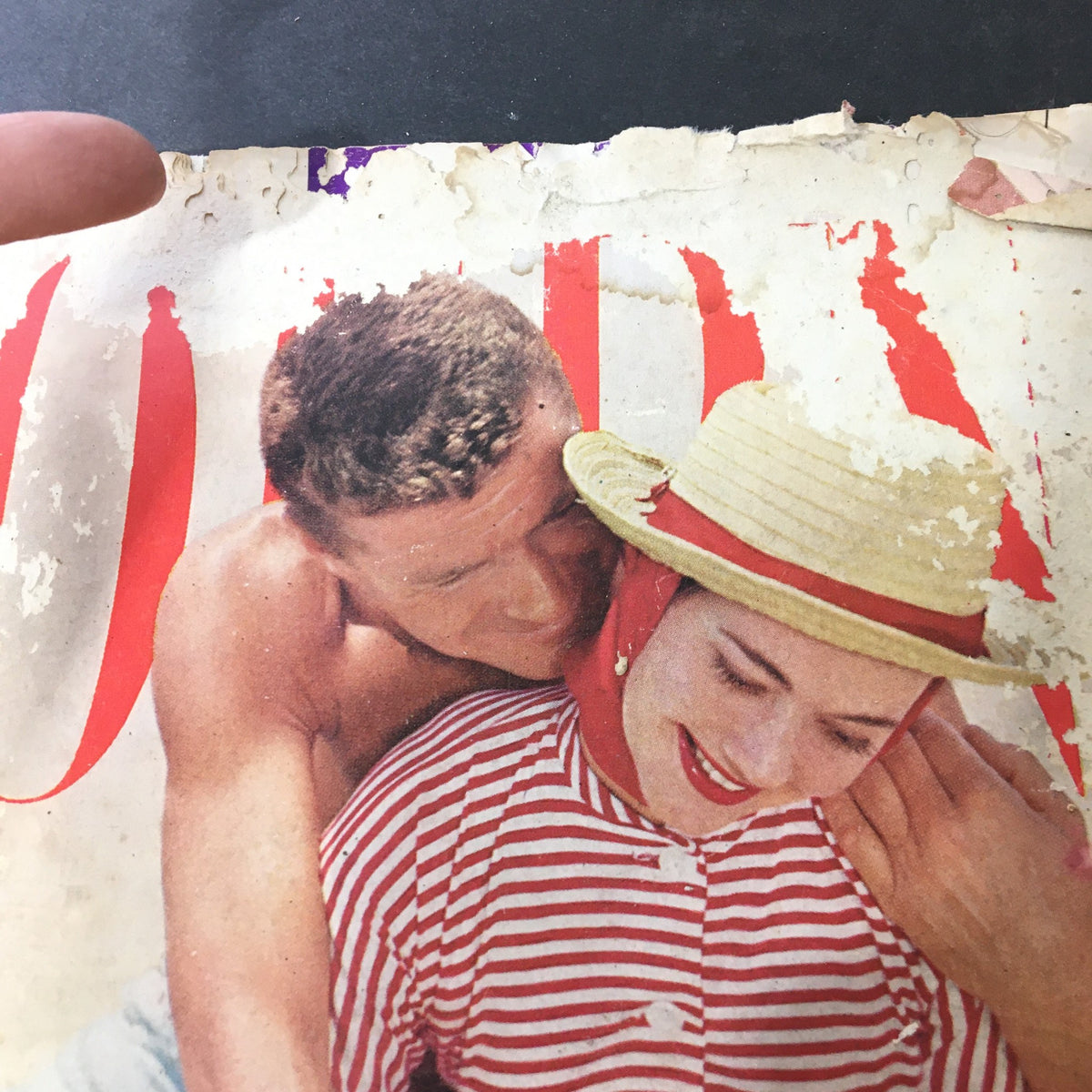 Detailed view of the vintage Journal Magazine July 1957 cover, focusing on the couple's playful pose, emphasizing its retro design and historical significance.