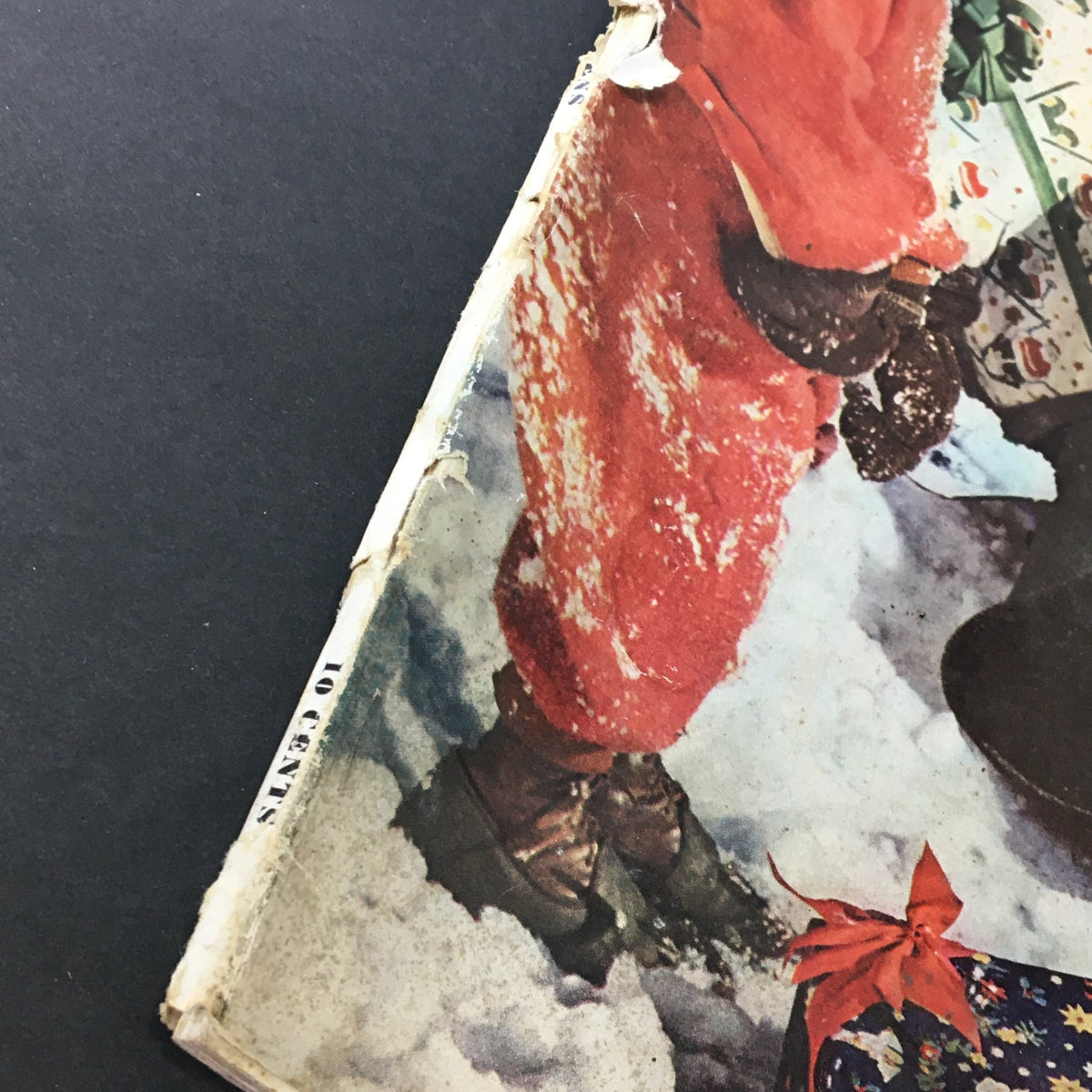 Side view of the VTG Better Homes & Gardens December 1940 magazine, showing a festive scene with a child in a red suit surrounded by snow.