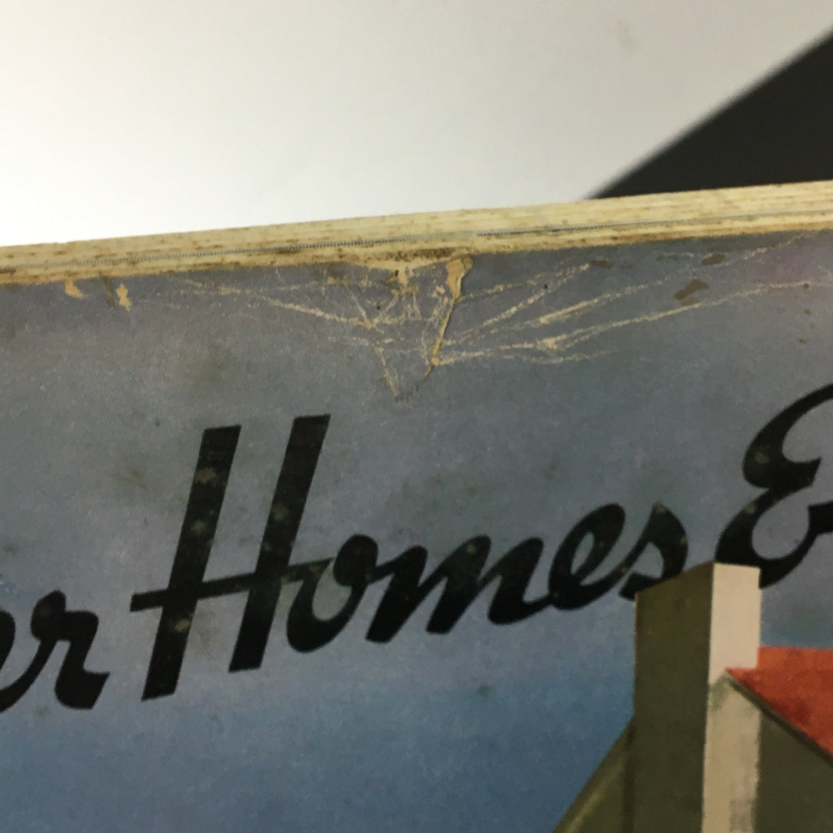 Close-up of the top edge of the Vintage Better Homes & Gardens magazine from March 1940, showcasing minor wear and frayed edges, indicative of its age and authenticity.