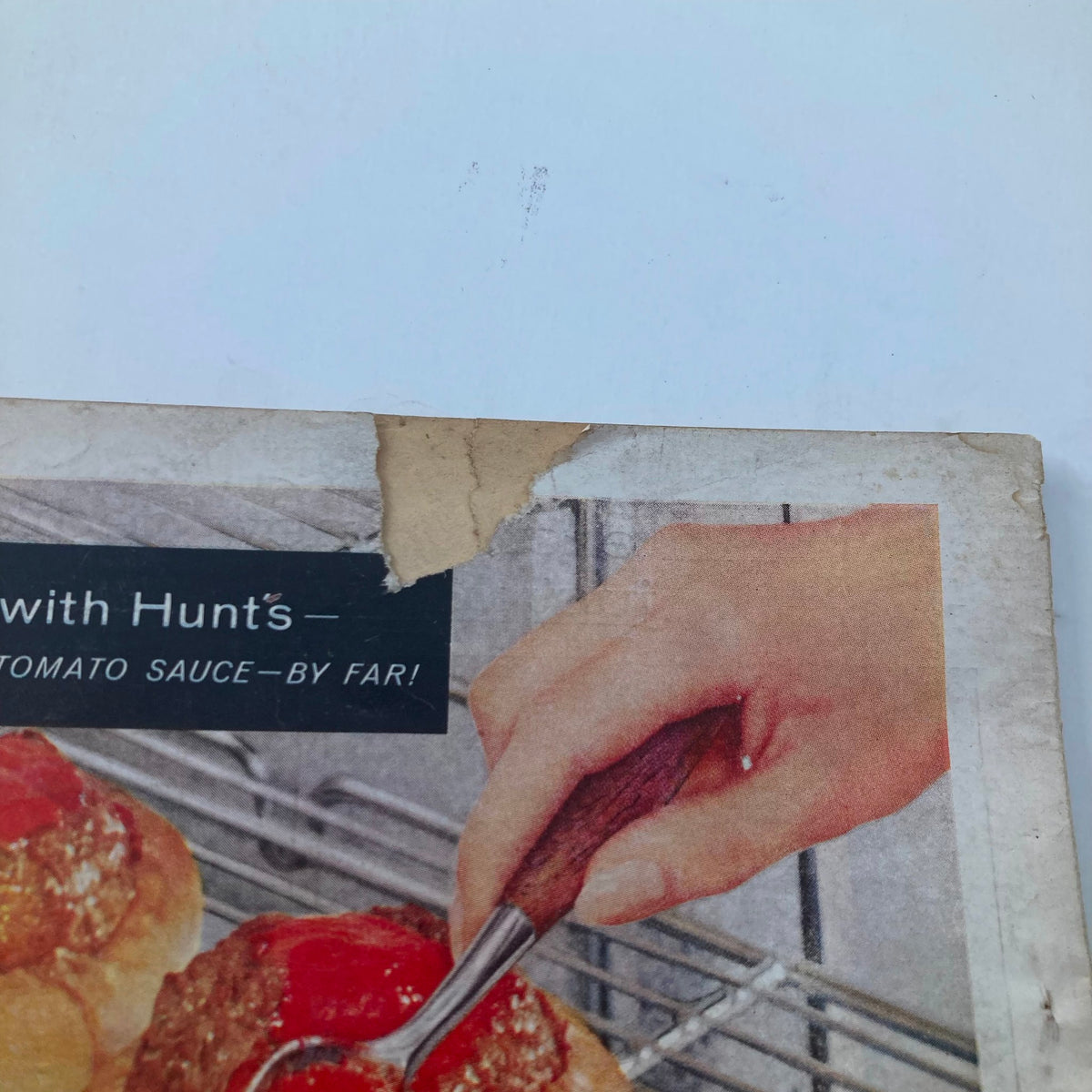Back cover of the November 1960 Redbook Magazine, showing a torn area while highlighting a vintage advertisement for Hunt's Tomato Sauce.