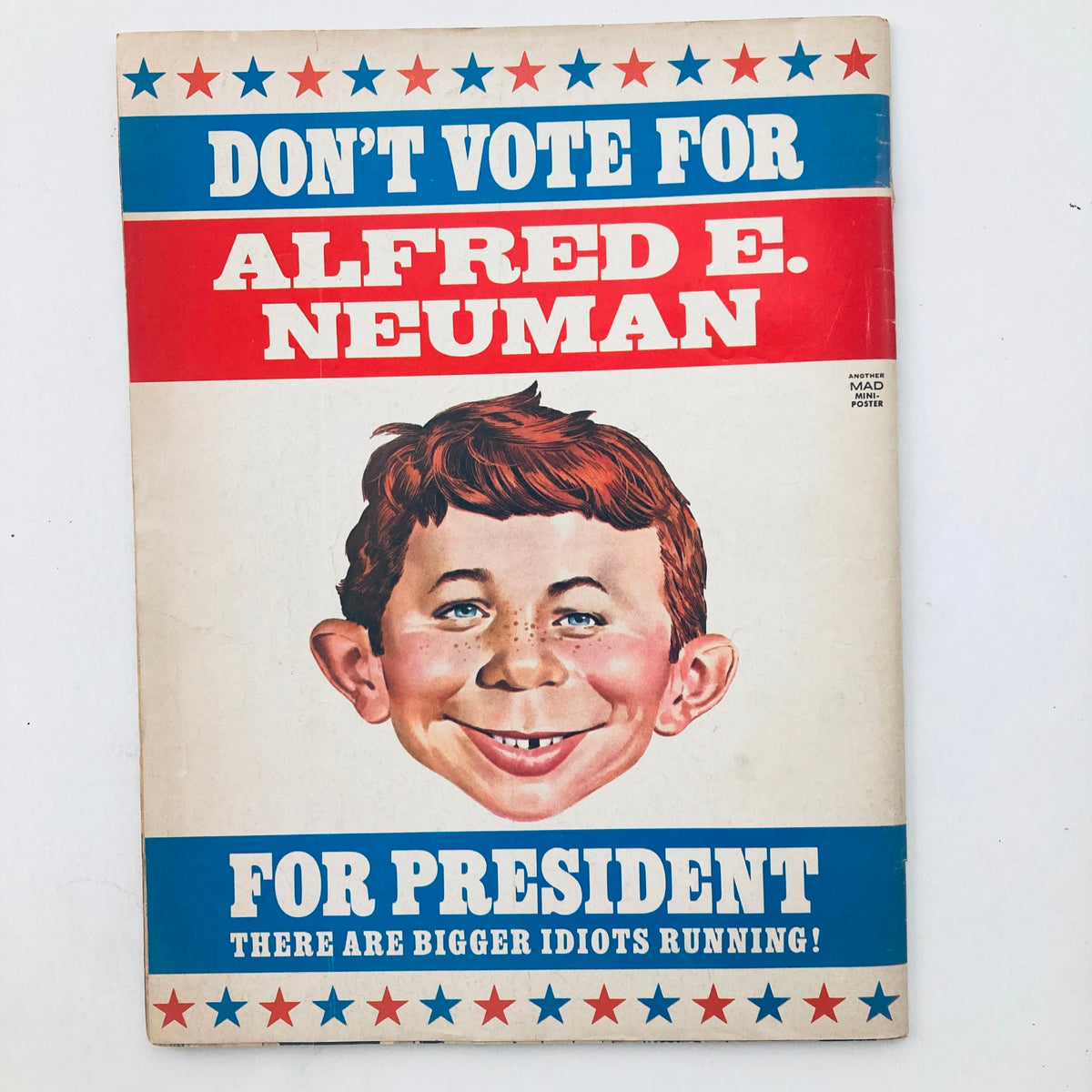 Poster from Mad Magazine featuring the character Alfred E. Neuman with the satirical caption 'Don't Vote for Alfred E. Neuman for President, There are Bigger Idiots Running!' showcasing the iconic humor of Mad Magazine. VTG Mad Magazine December 1976 No. 187 Henry Winkler The Fonz 4.0 VG No Label.