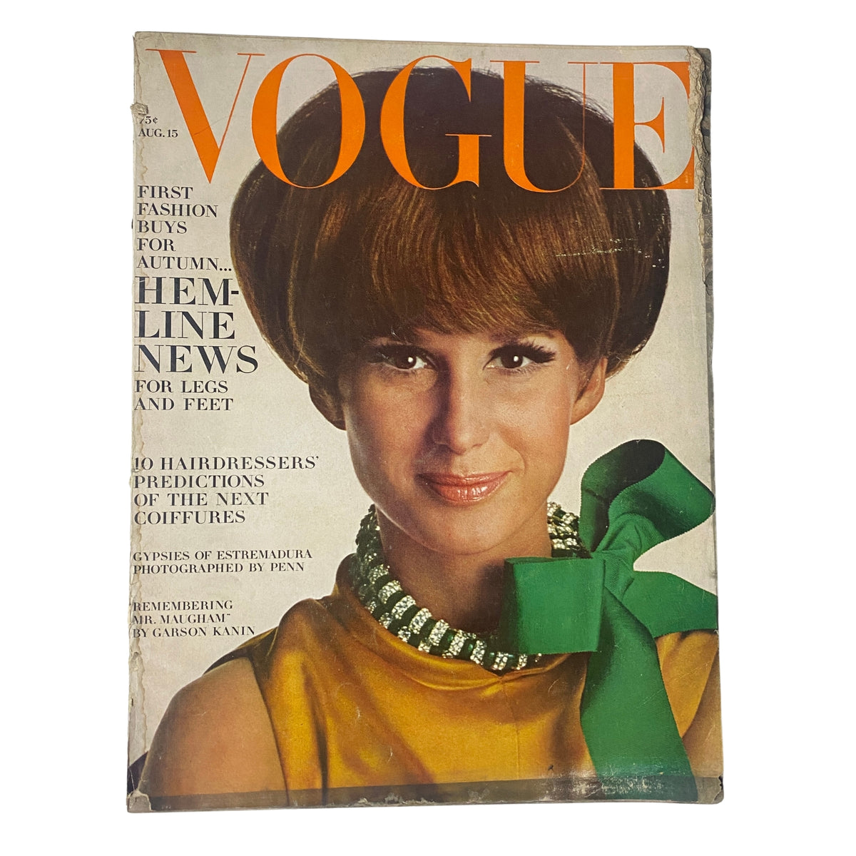 Cover of Vogue Magazine from August 15, 1966, featuring Brigitte Bauer with a stylish bob hairstyle and wearing a striking yellow outfit with a green bow, photographed by Irving Penn.