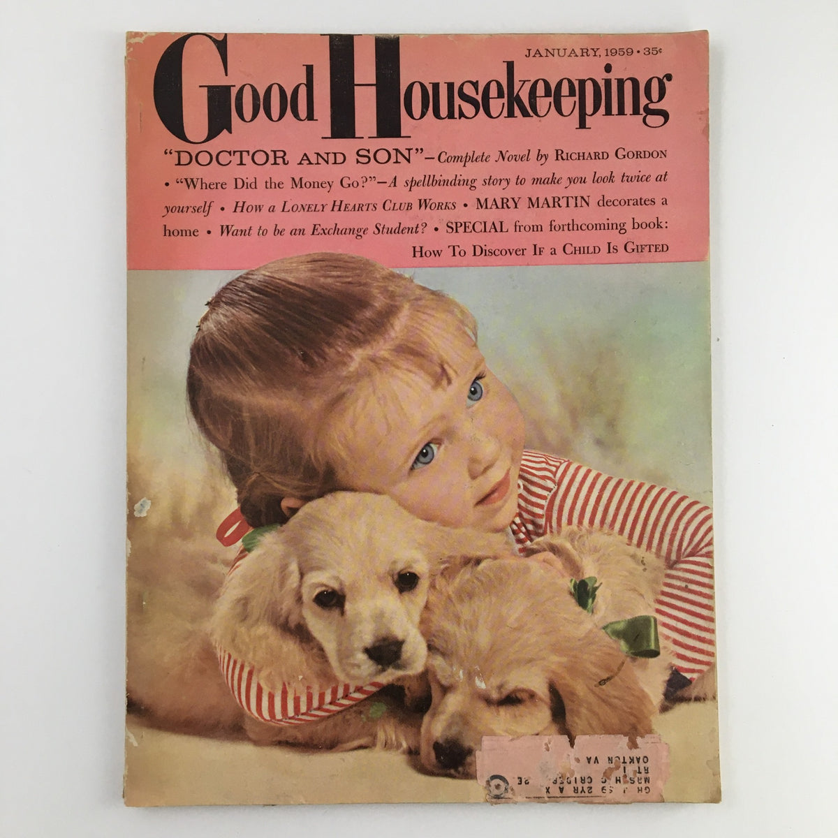 Cover of Good Housekeeping Magazine January 1959 featuring a girl with blonde hair in a striped shirt, cuddling two puppies, and a title about the story 'The Night I Was Almost Miss America'.